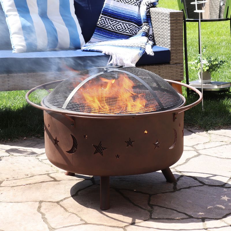 Sunnydaze Outdoor Camping or Backyard Round Cosmic Stars and Moons Fire Pit with Cooking Grill Grate, Spark Screen, and Log Poker – 30″